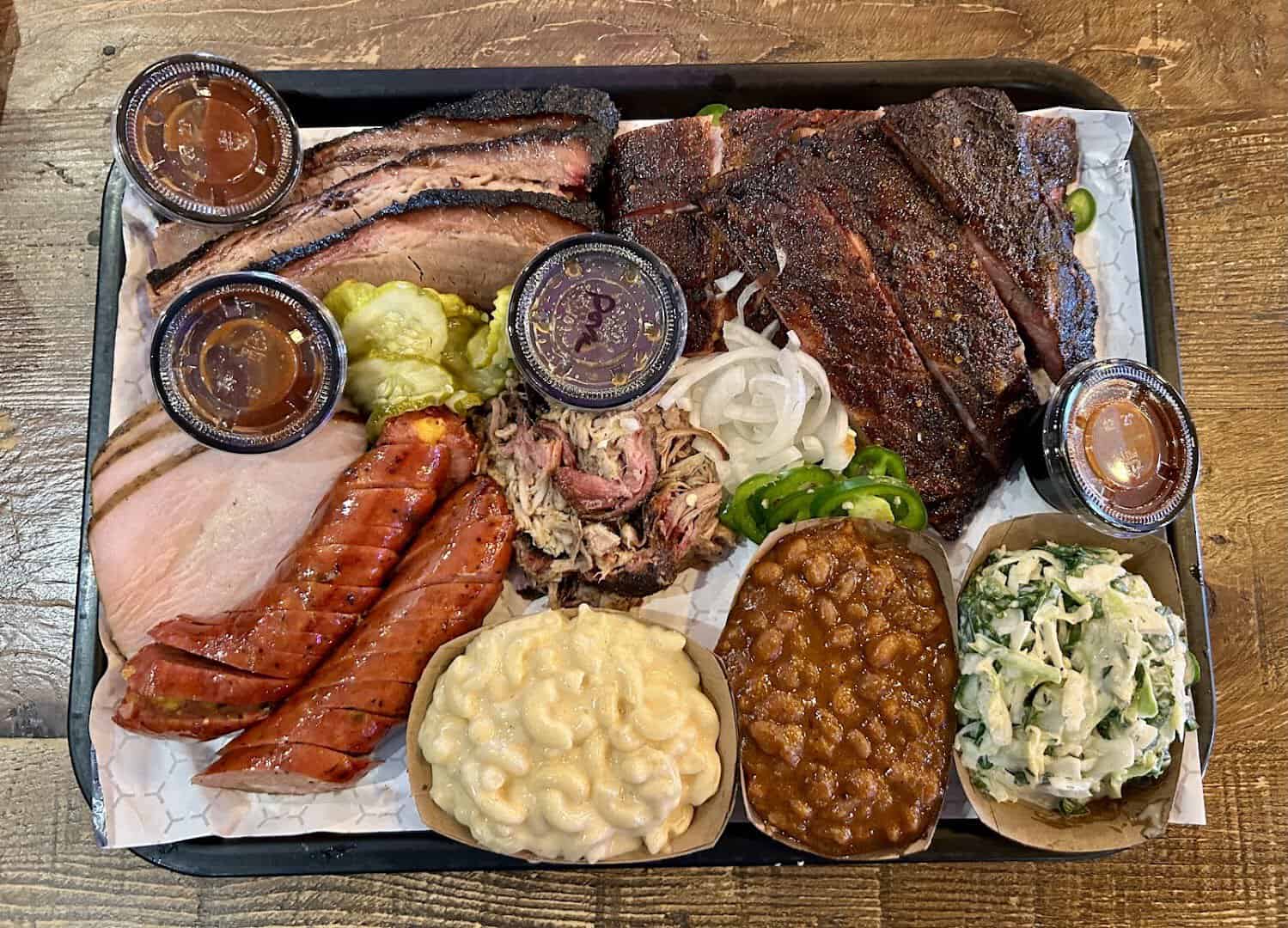 Large platter of brisket, sausage, turkey and sides at CorkScrew BBQ in Spring, Texas