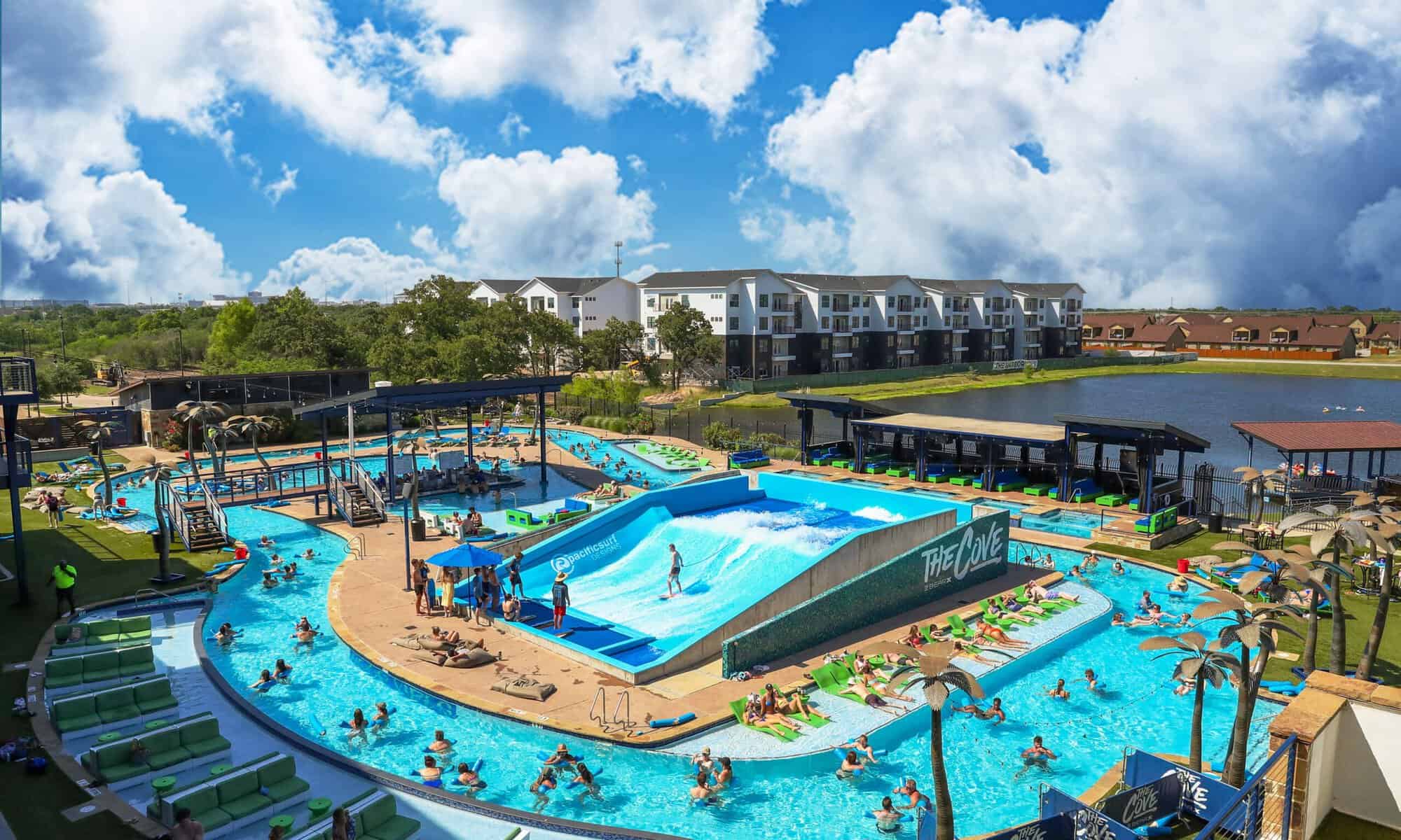 Aerial daytime view of the pool, lazy river and surf wave at The Cove at BearX in College Station, Texas