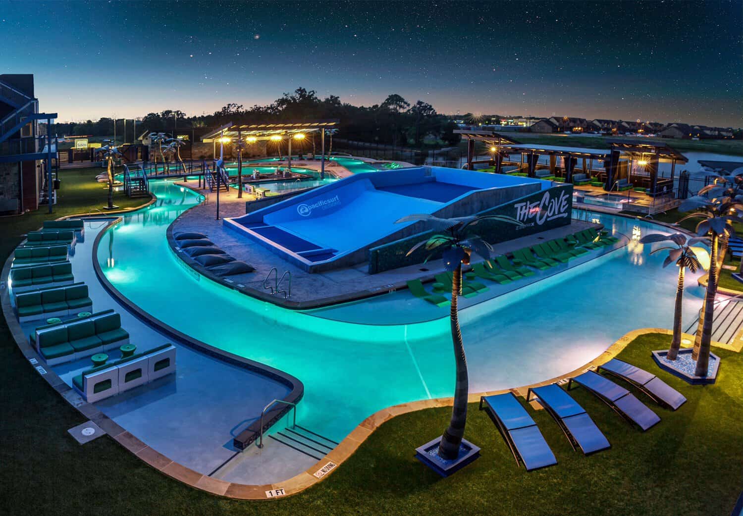 Aerial view of the pool complex at dusk at The Cove at BearX in College Station, Texas