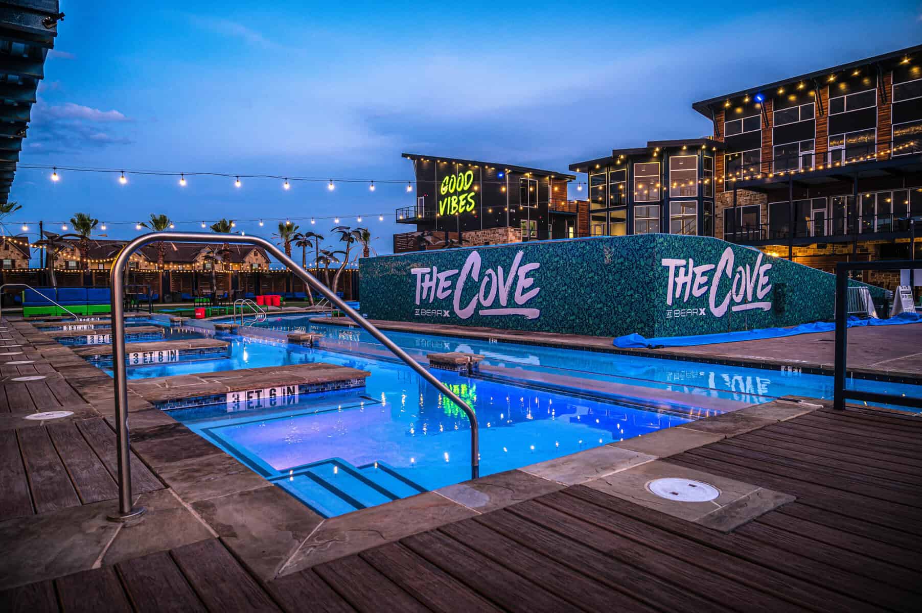 The Cove at BearX resort pool lit up at dusk in College Station, Texas