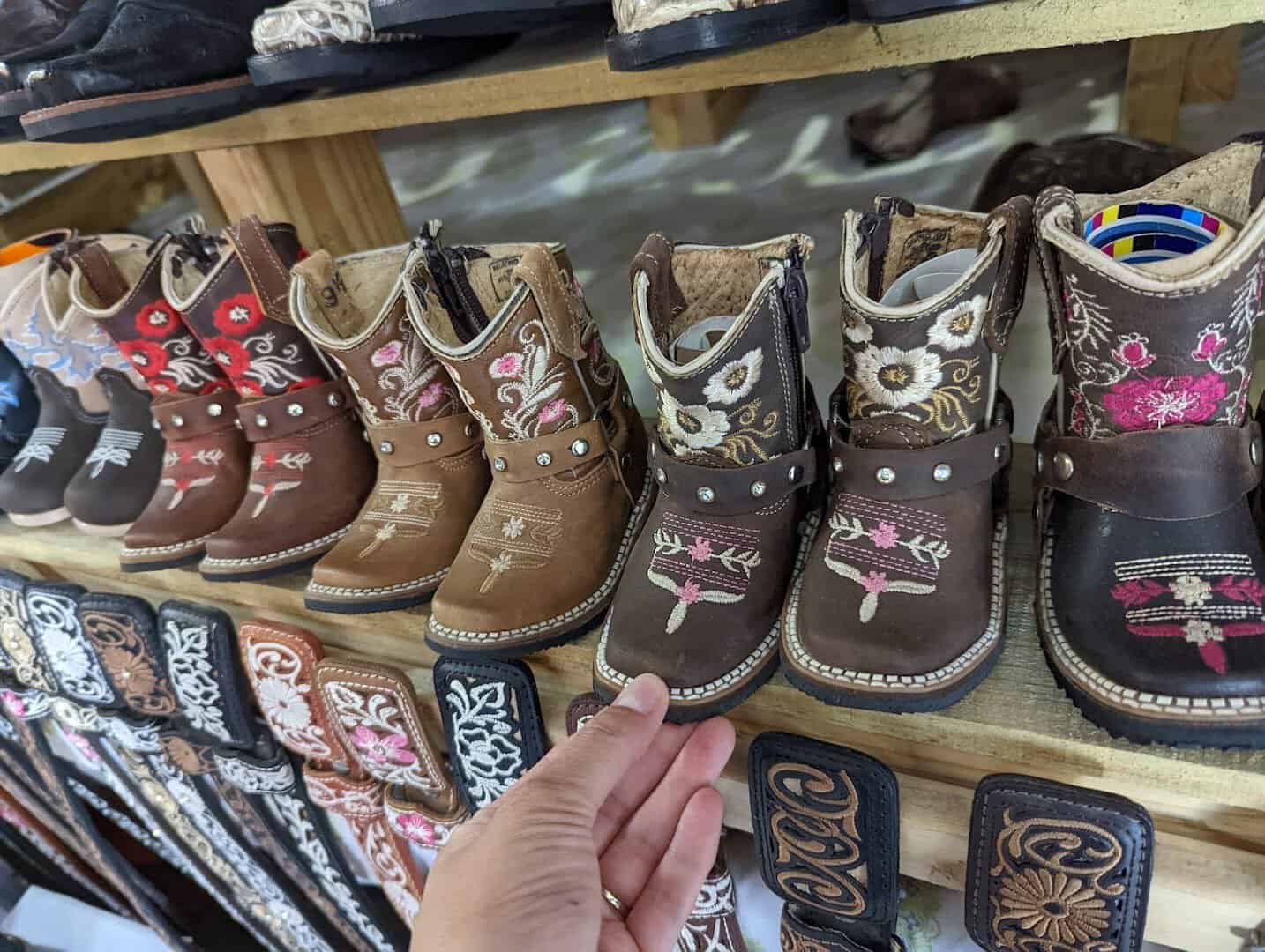 Rows of cowboy boots for sale at 77 Flea Market in Brownsville, Texas