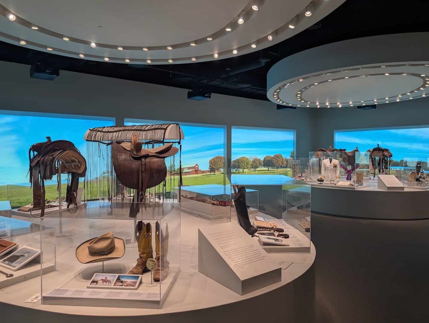 Gallery with saddle and artifact displays inside the National Cowgirl Museum in Fort Worth