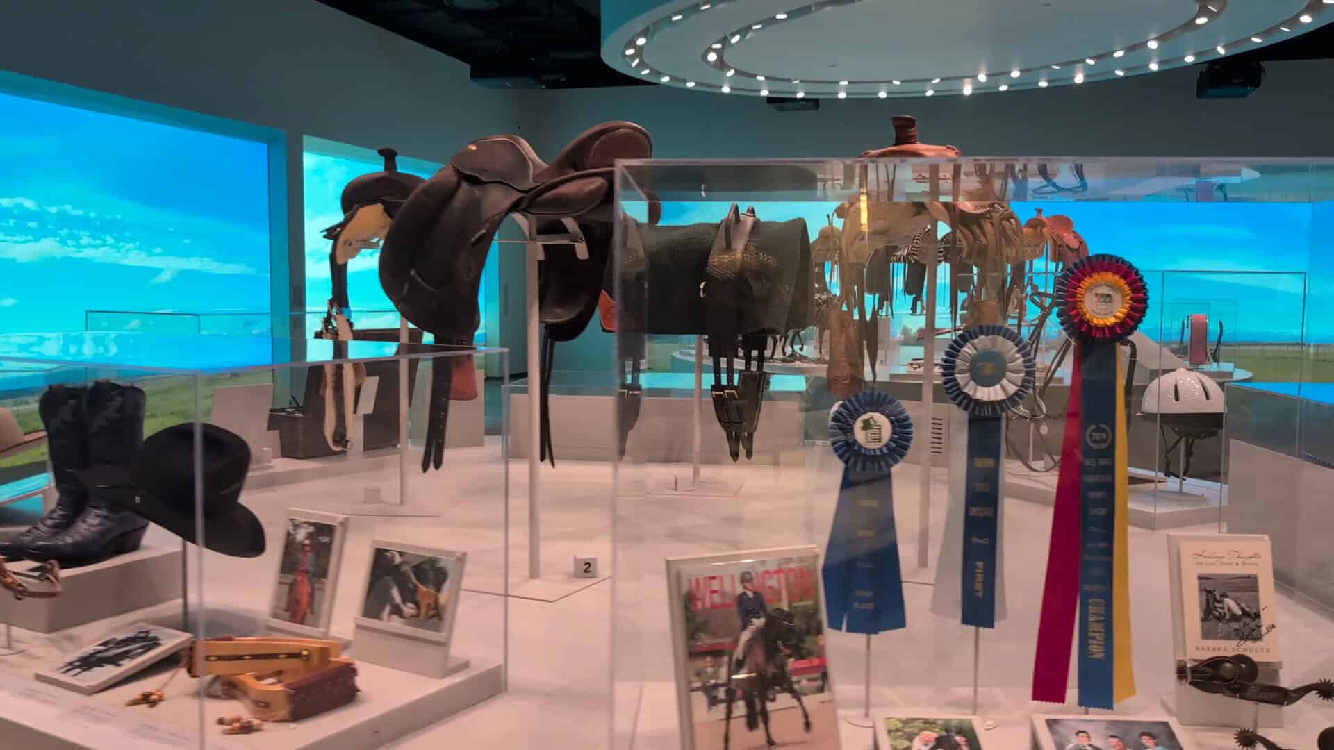Saddles and rodeo prize ribbons on display at the National Cowgirl Museum in Fort Worth