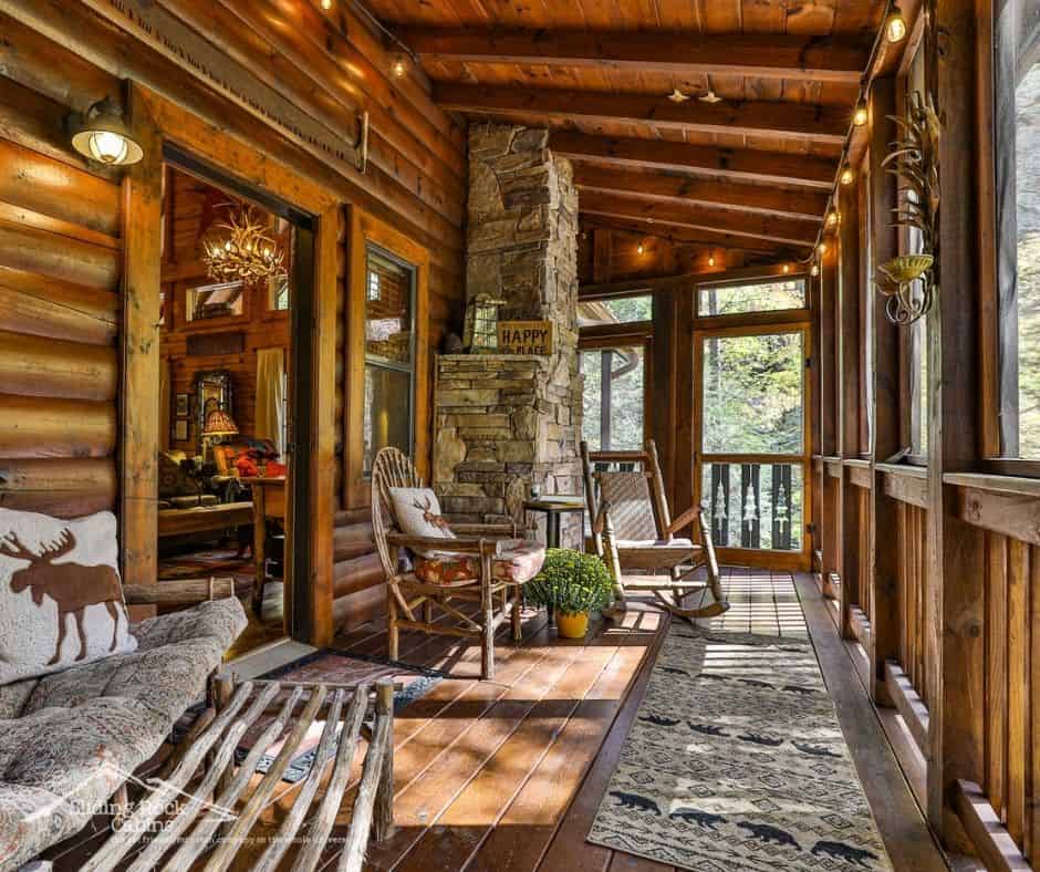 Cozy cabin screened porch with rocking chairs and string lights at Sliding Rock Cabins near Blue Ridge, Georgia