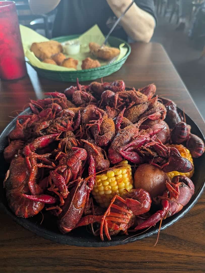 Tray of seasoned boiled crawfish with corn and potato at Fish Shack in Plano, Texas