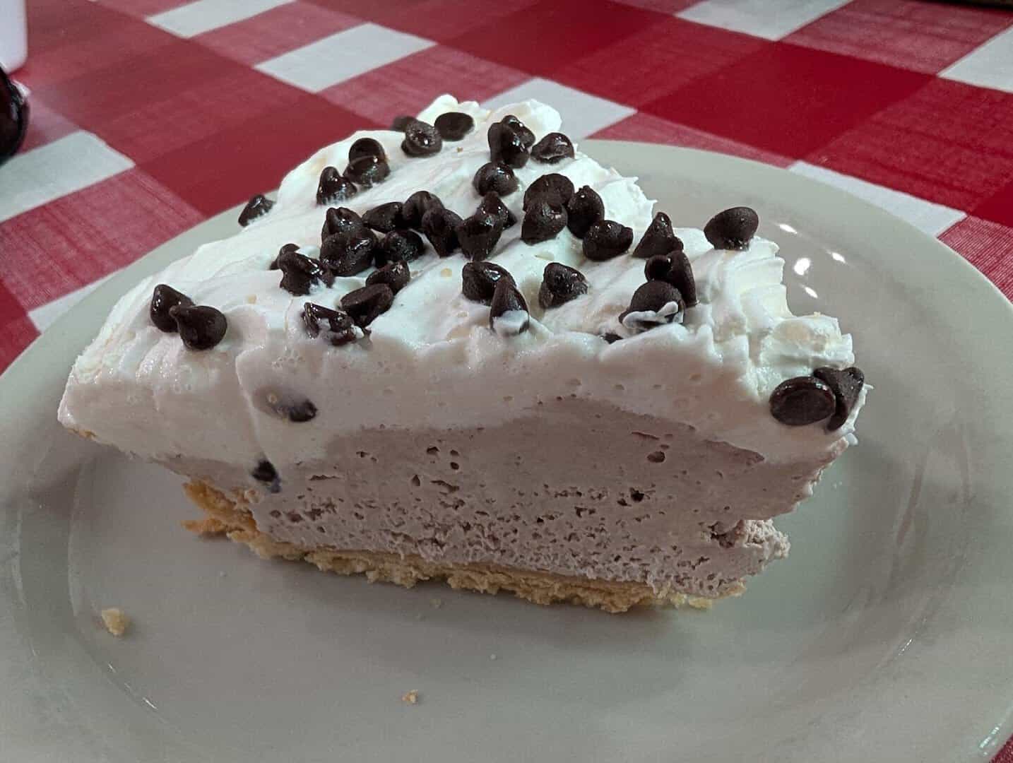 Tall slice of cream pie topped with chocolate chips at Texan Cafe and Pie Shop in Hutto, Texas