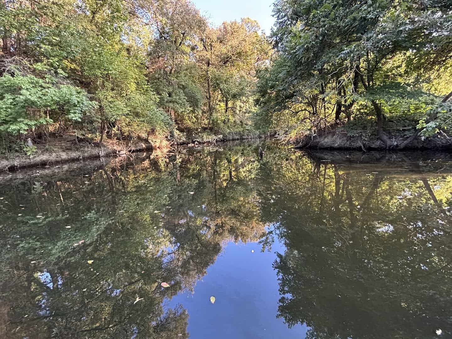 Calm creek pool below the waterfall at Prairie Creek Park in Richardson, Texas