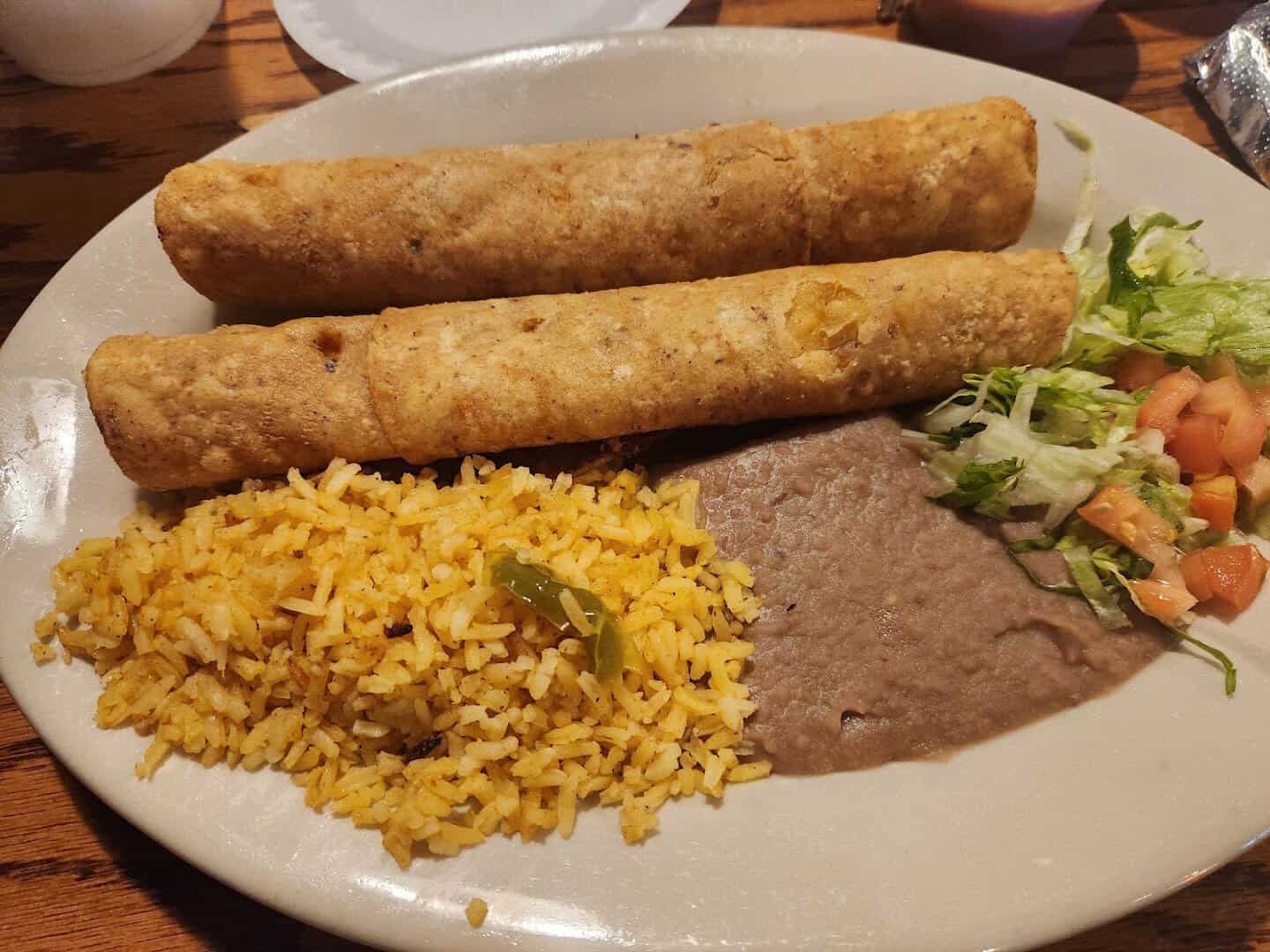 Crispy rolled tacos with rice and refried beans at Ray's Drive Inn in San Antonio