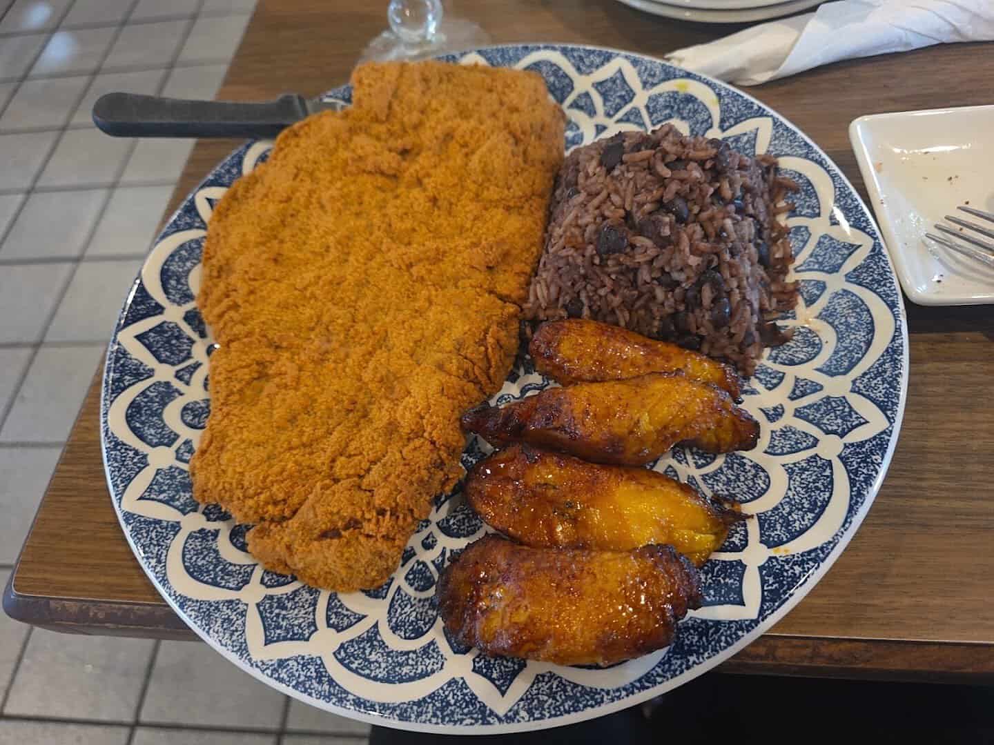Breaded Cuban steak plate with plantains, black beans and rice at Cafe Piquet in Bellaire, Texas