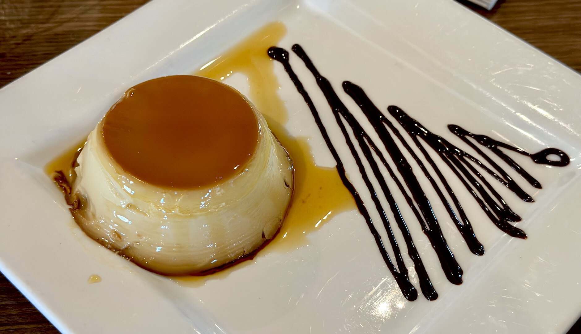 Cuban flan with caramel and chocolate drizzle at Cafe Piquet in Bellaire, Texas
