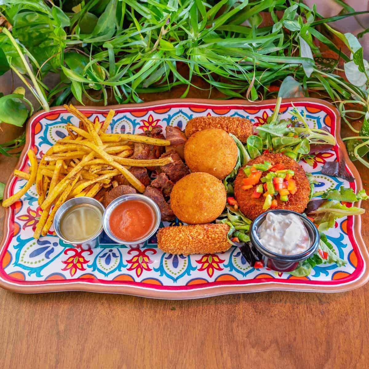 Sampler platter of croquetas, yuca fries and mango salsa at Habana in Austin