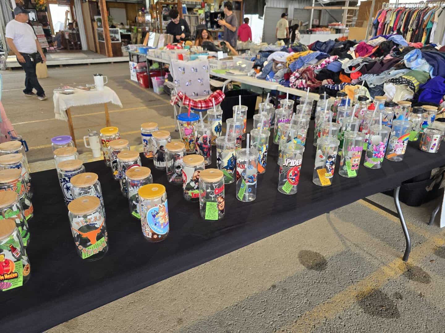 Tables of colorful cups and goods at Austin Country Flea Market
