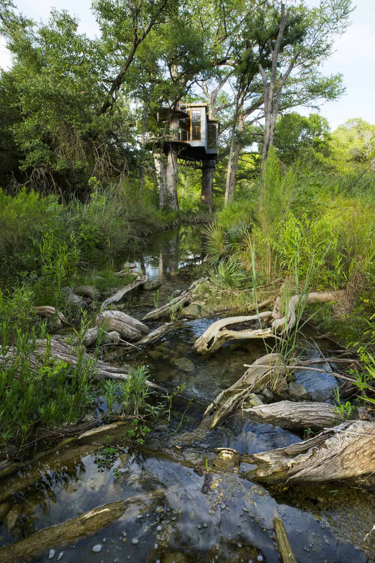 Treehouse on stilts by the creek at Cypress Valley in Spicewood, Texas