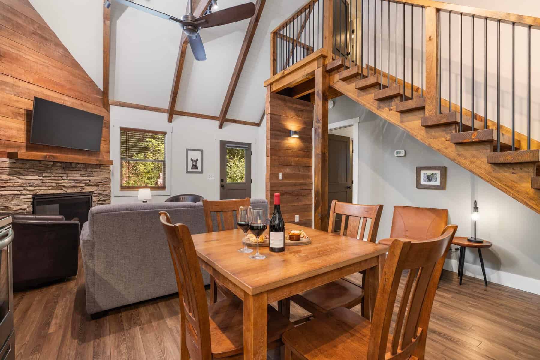 Cozy cabin living room with wood beams and a loft at Dancing Bear Lodge in Townsend, Tennessee