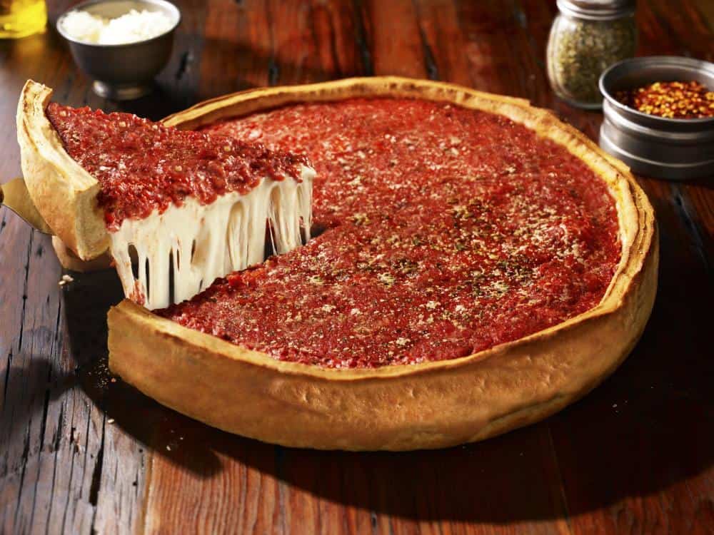 Deep-dish pizza with a cheese pull at Lou Malnati's in Chicago, Illinois