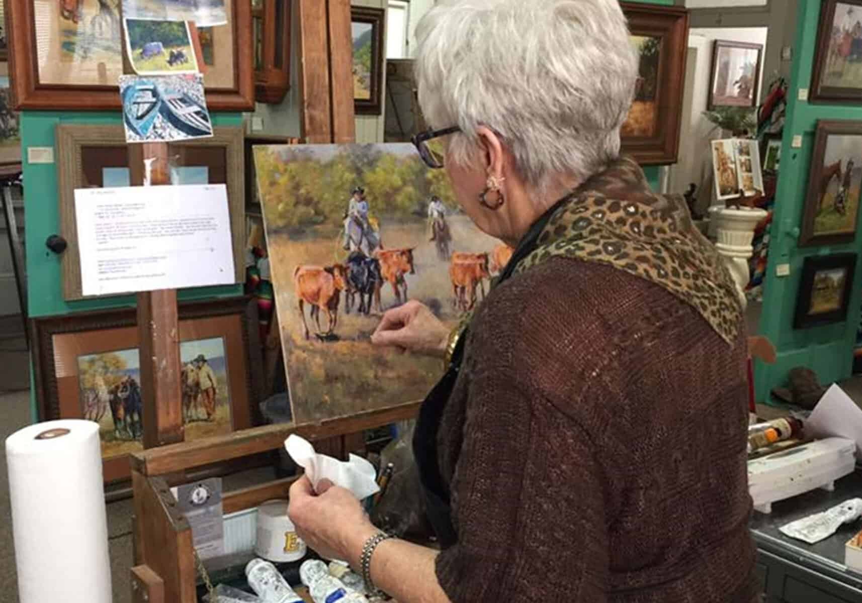 An artist painting at a gallery in Del Rio, Texas