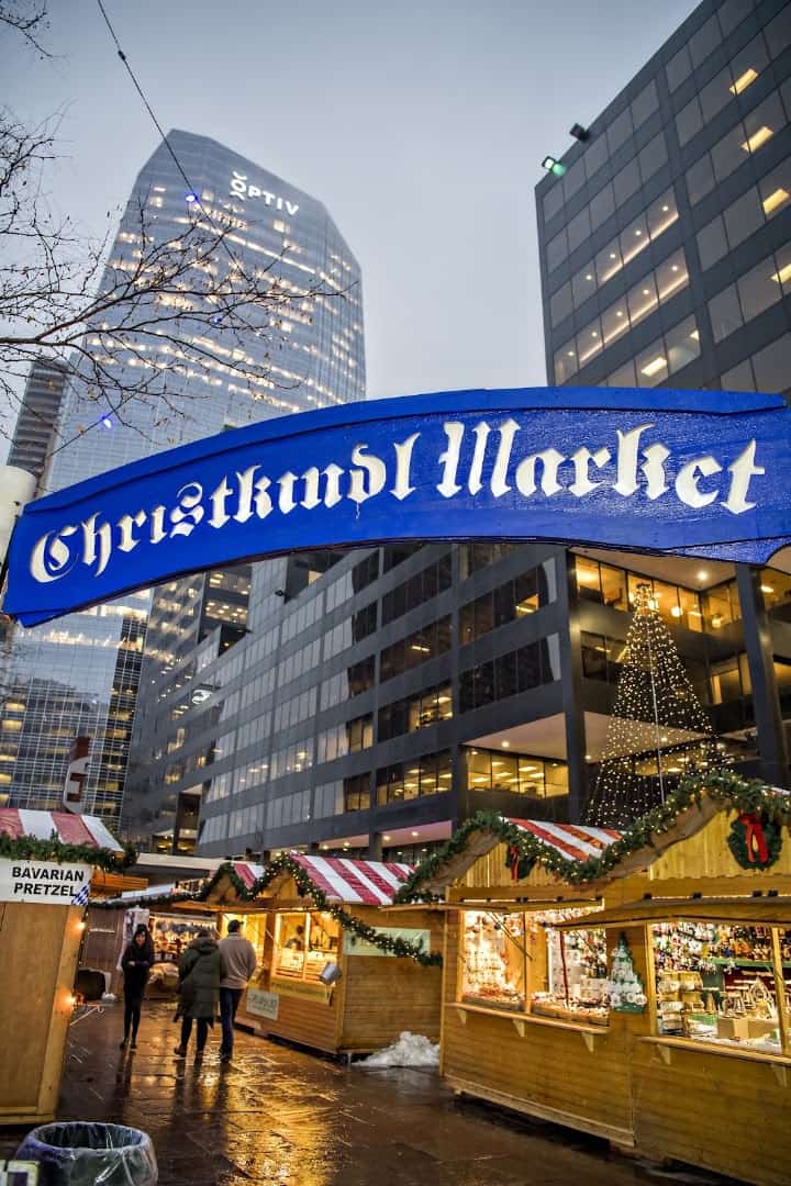 Christkindl Market banner over lit stalls at the Denver Christkindlmarket in Colorado