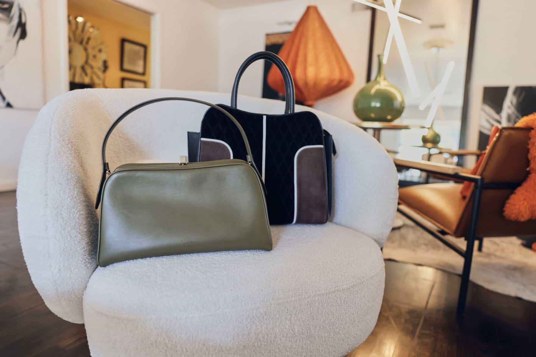 Designer handbags styled on a chair at Clotheshorse Anonymous in Dallas