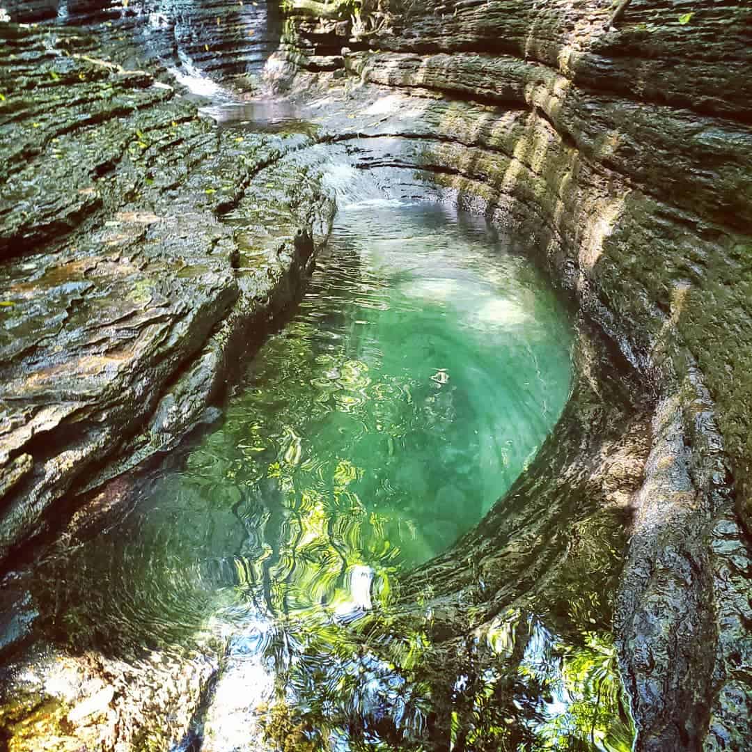 The teardrop-shaped Devil's Bathtub pool in blue-green rock near Fort Blackmore, Virginia