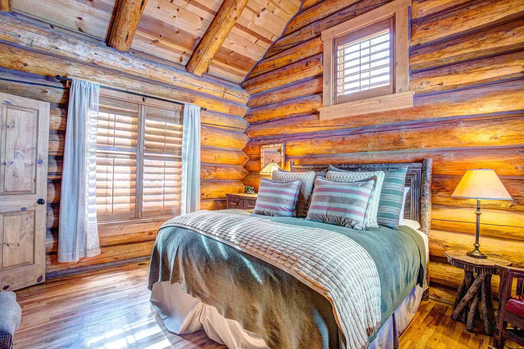 Cozy log cabin bedroom at Devil's Thumb Ranch in Tabernash, Colorado