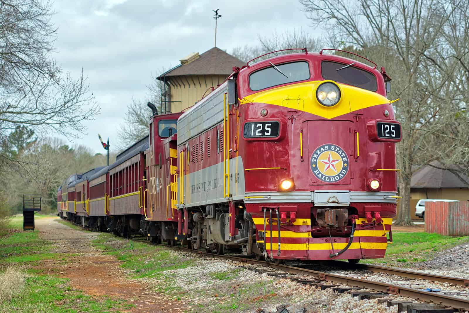 Restored vintage diesel locomotive 125 with maroon coaches on the Texas State Railroad