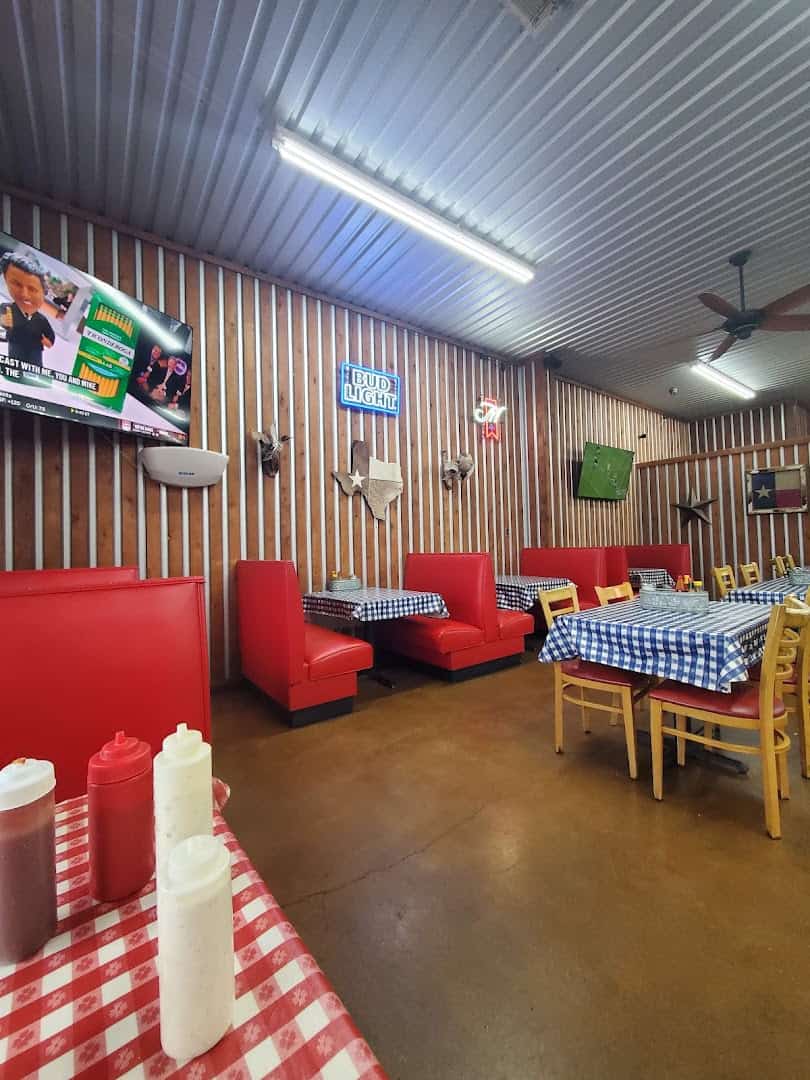 Red booths in the dining room at the Farm House in Mexia, Texas