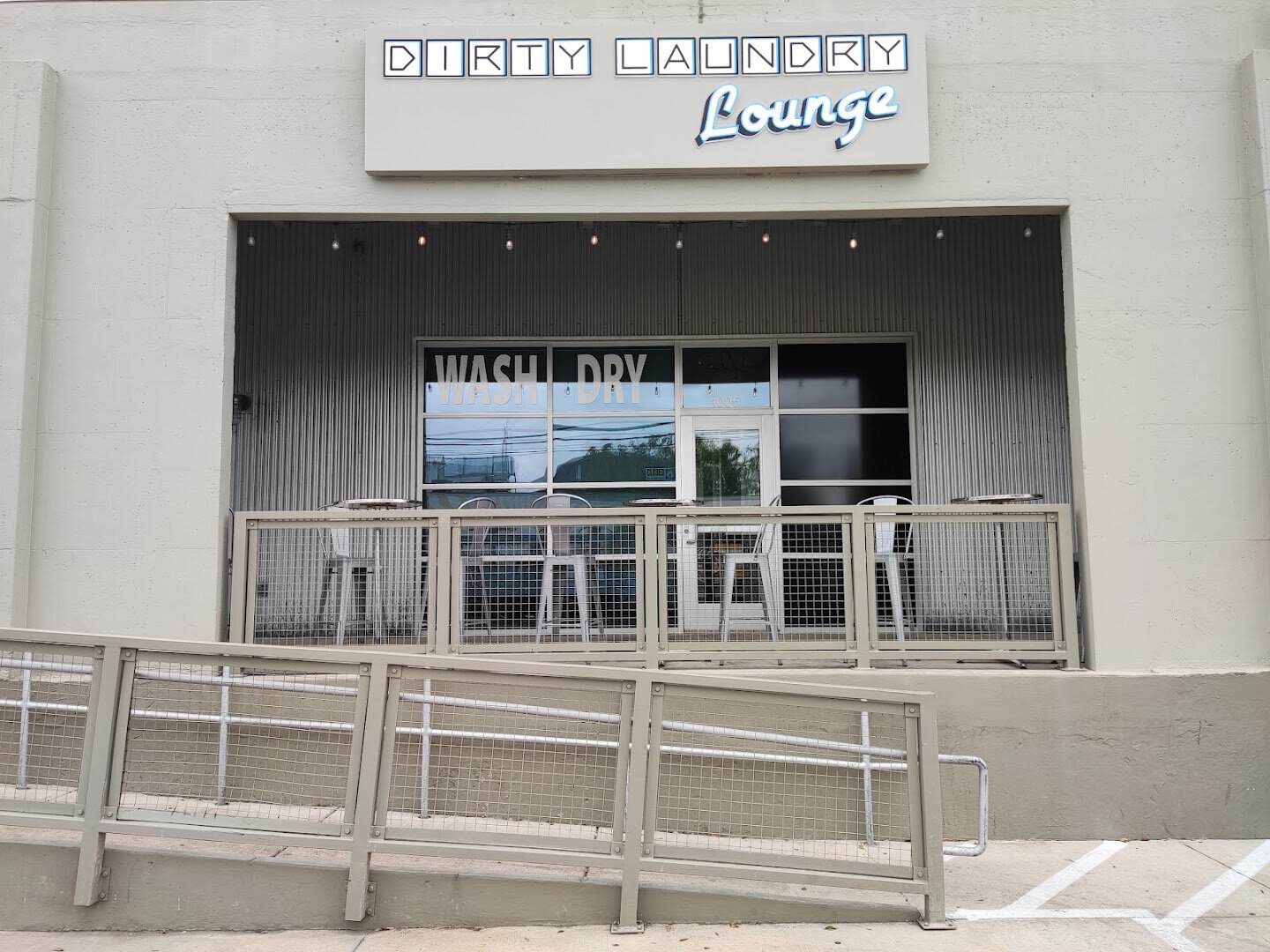 The Dirty Laundry laundromat storefront and sign in Fort Worth