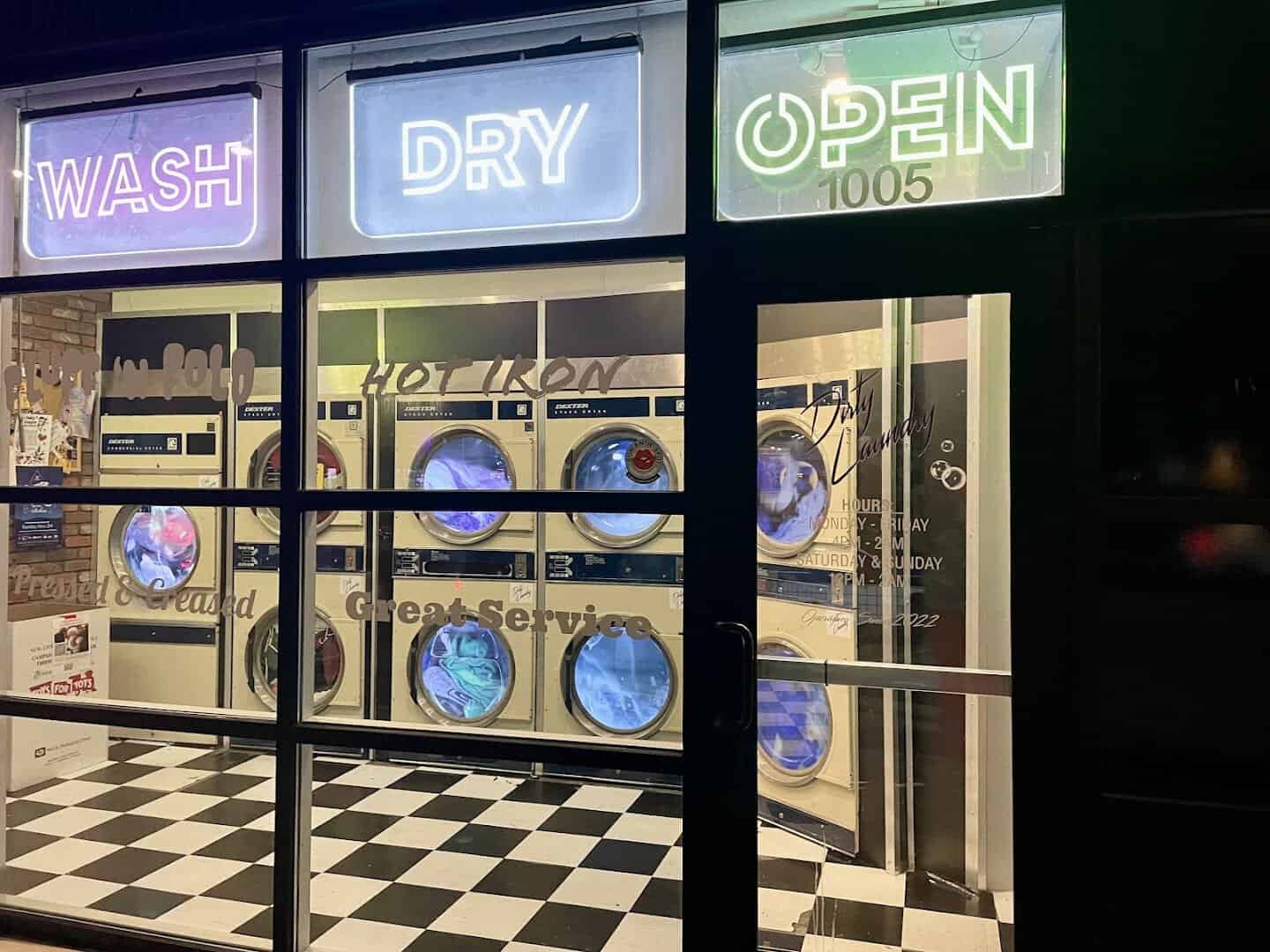 Night view of the Wash Dry Open neon storefront hiding Dirty Laundry speakeasy in Fort Worth