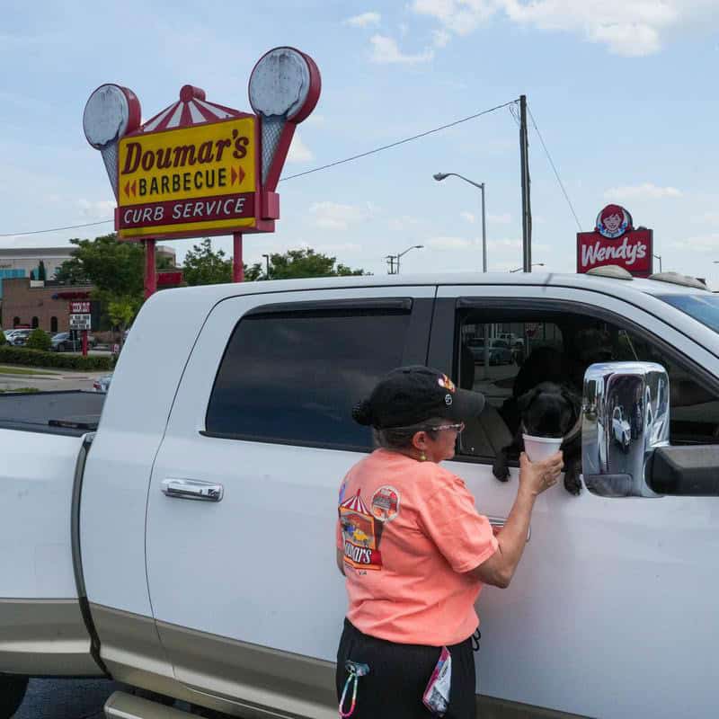 Doumar's Barbecue curb service sign and carhop in Norfolk, Virginia