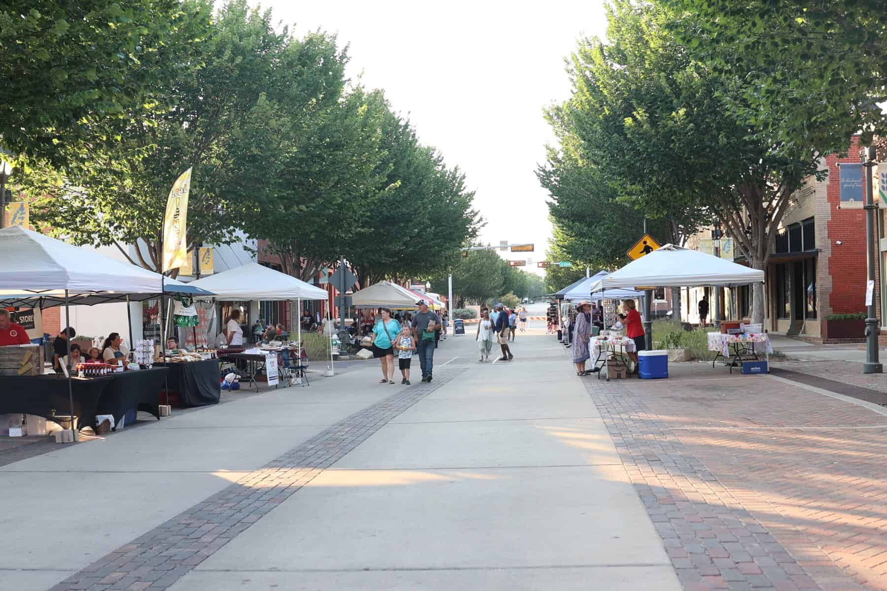Visitors filling a tree-lined downtown Ennis street during the festival