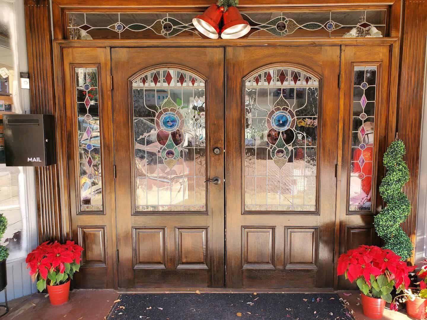 Ornate stained glass shop doors on a downtown storefront in Nacogdoches, Texas