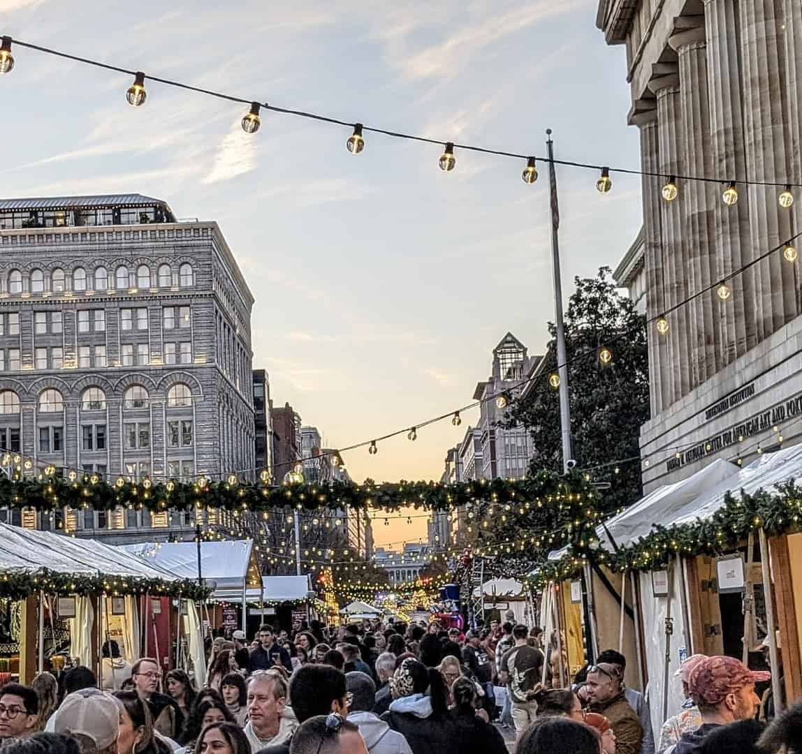 String-lit market lane and crowd at the DowntownDC Holiday Market in Washington, D.C.