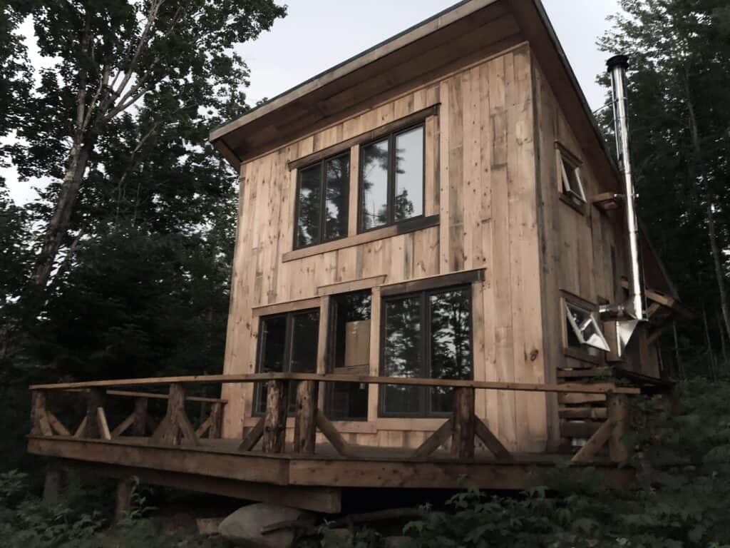 Hand-built solar Ravenwood cabin in the woods at Drift Farmstead, Roxbury, Vermont
