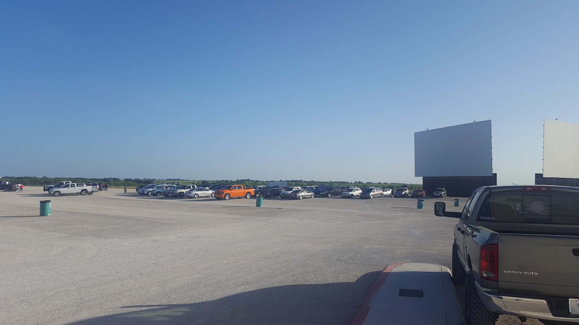 The drive-in lot filling with cars before the show in New Braunfels, Texas