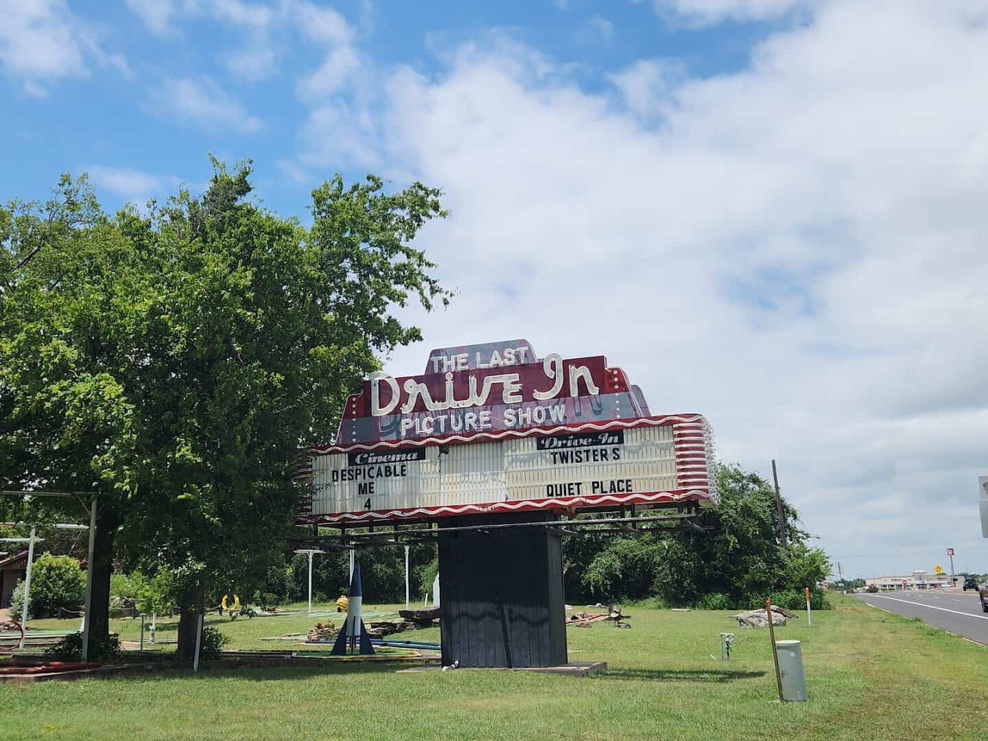 The roadside marquee of The Last Drive-In Picture Show under a blue sky in Gatesville, Texas