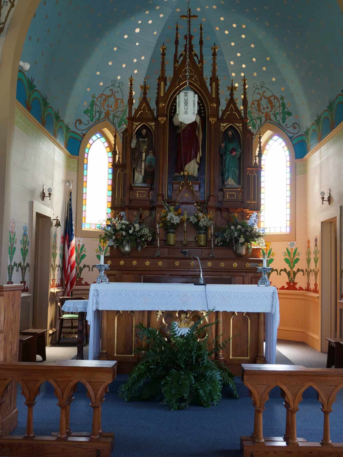 Wide view of the main altar and star-filled blue ceiling inside a historic Czech church in Dubina, Texas