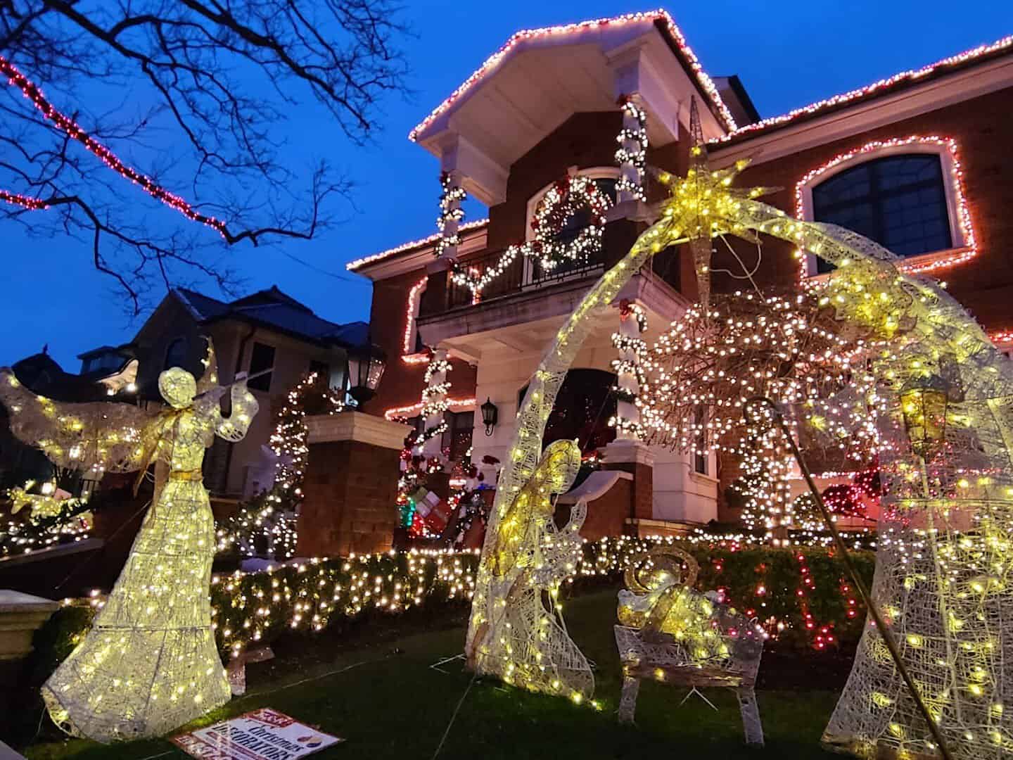 House covered in Christmas lights and lit angel displays at night in Dyker Heights, Brooklyn, New York