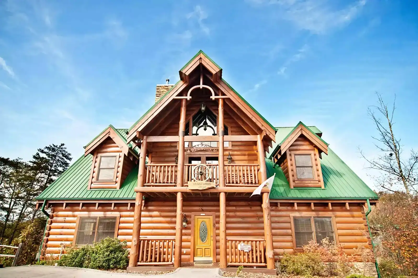 A-frame log cabin under blue sky at Eagles Ridge Resort in Pigeon Forge, Tennessee