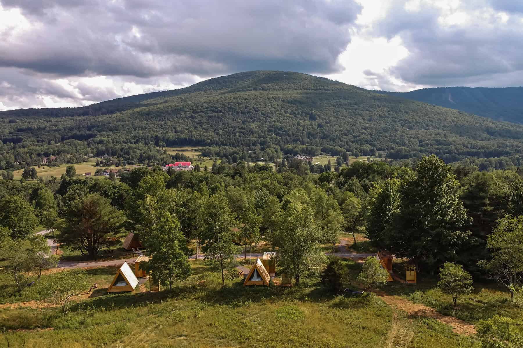 A-frame Lushna cabins in a meadow at Eastwind in Windham, New York