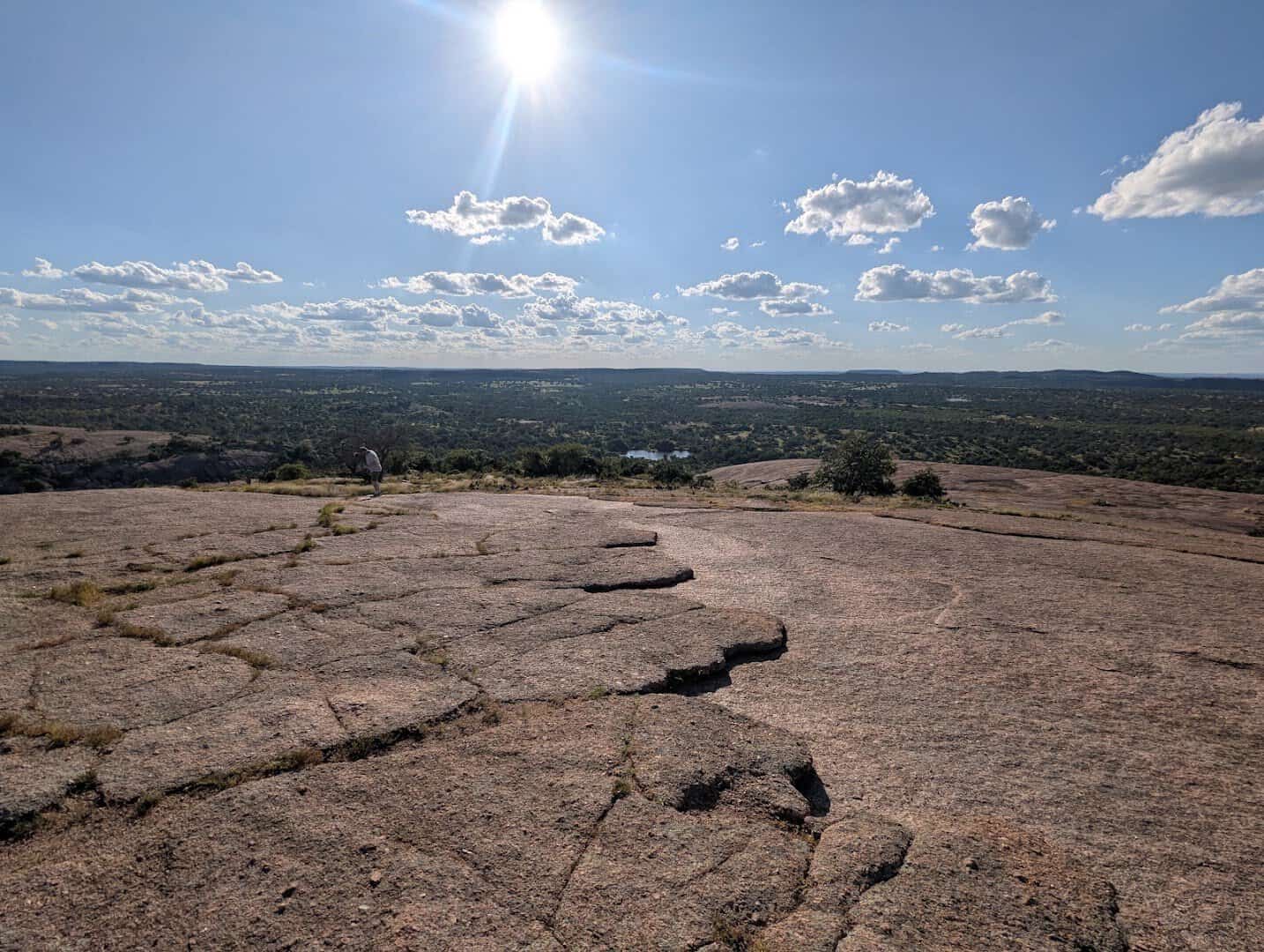 The cracked granite summit and sweeping Hill Country view atop Enchanted Rock near Fredericksburg, Texas