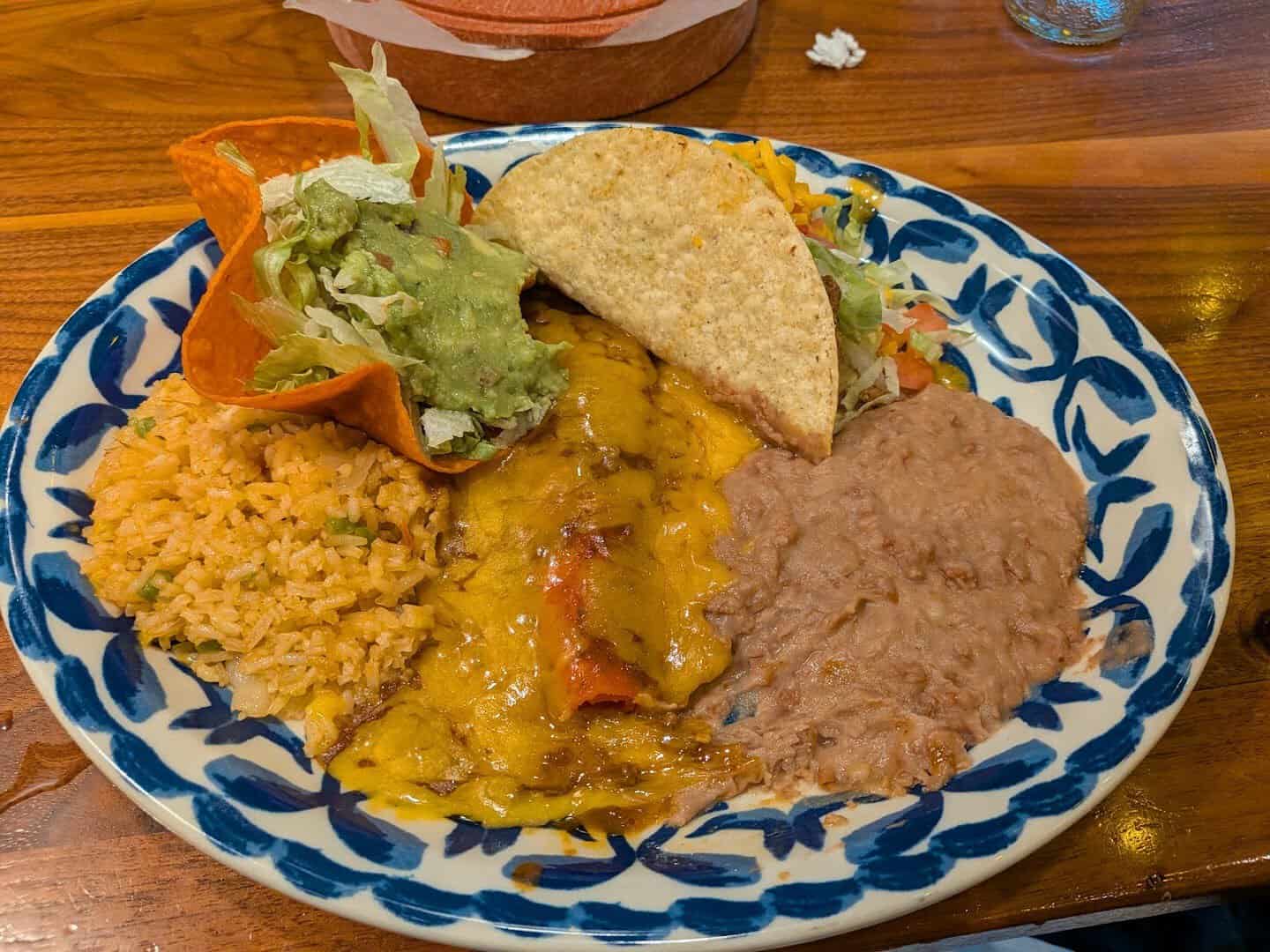 Enchiladas verdes with rice, beans and guacamole at Mi Familia at the Rim in San Antonio