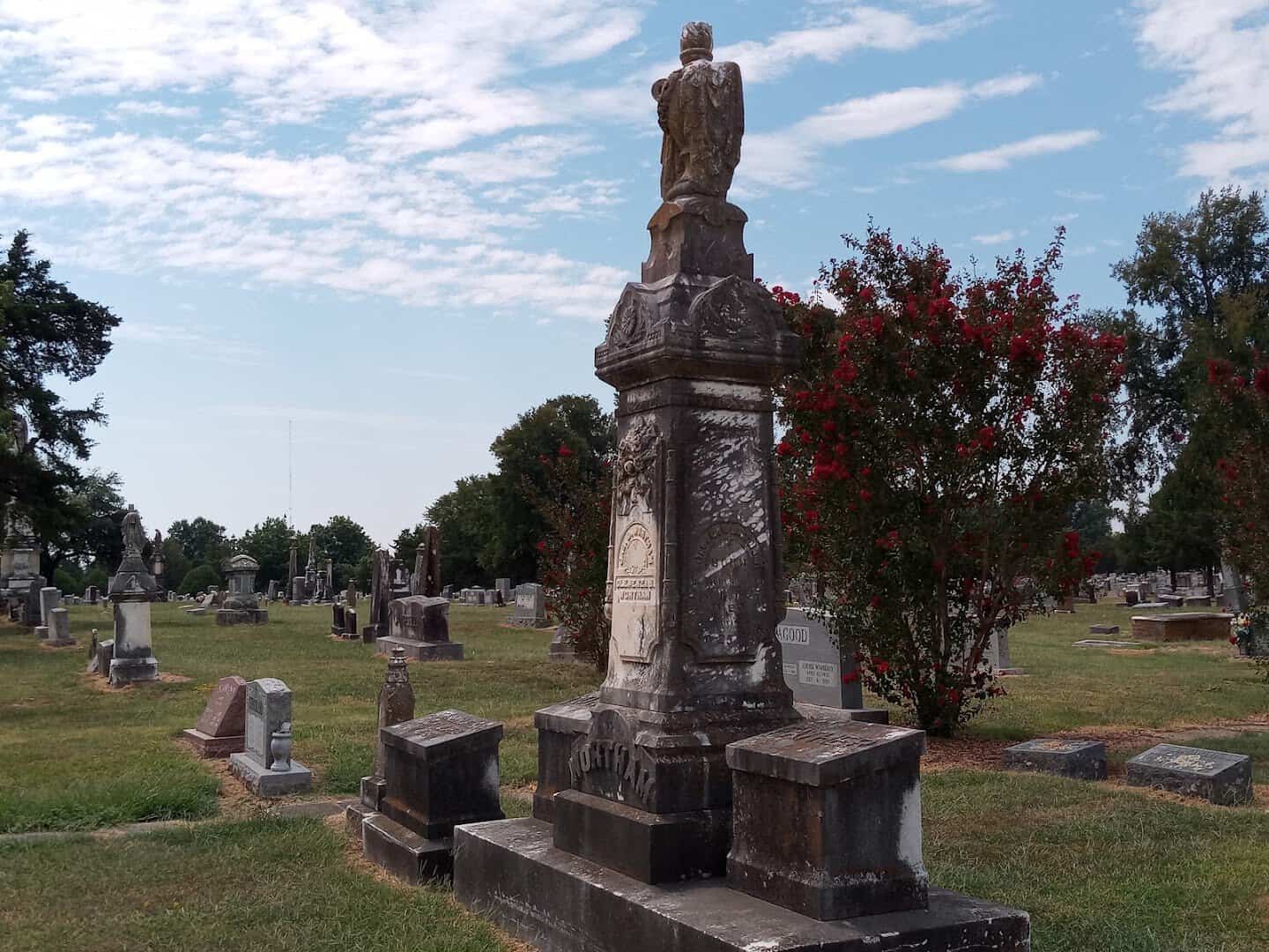 A tall carved monument in Evergreen Cemetery, Paris, Texas