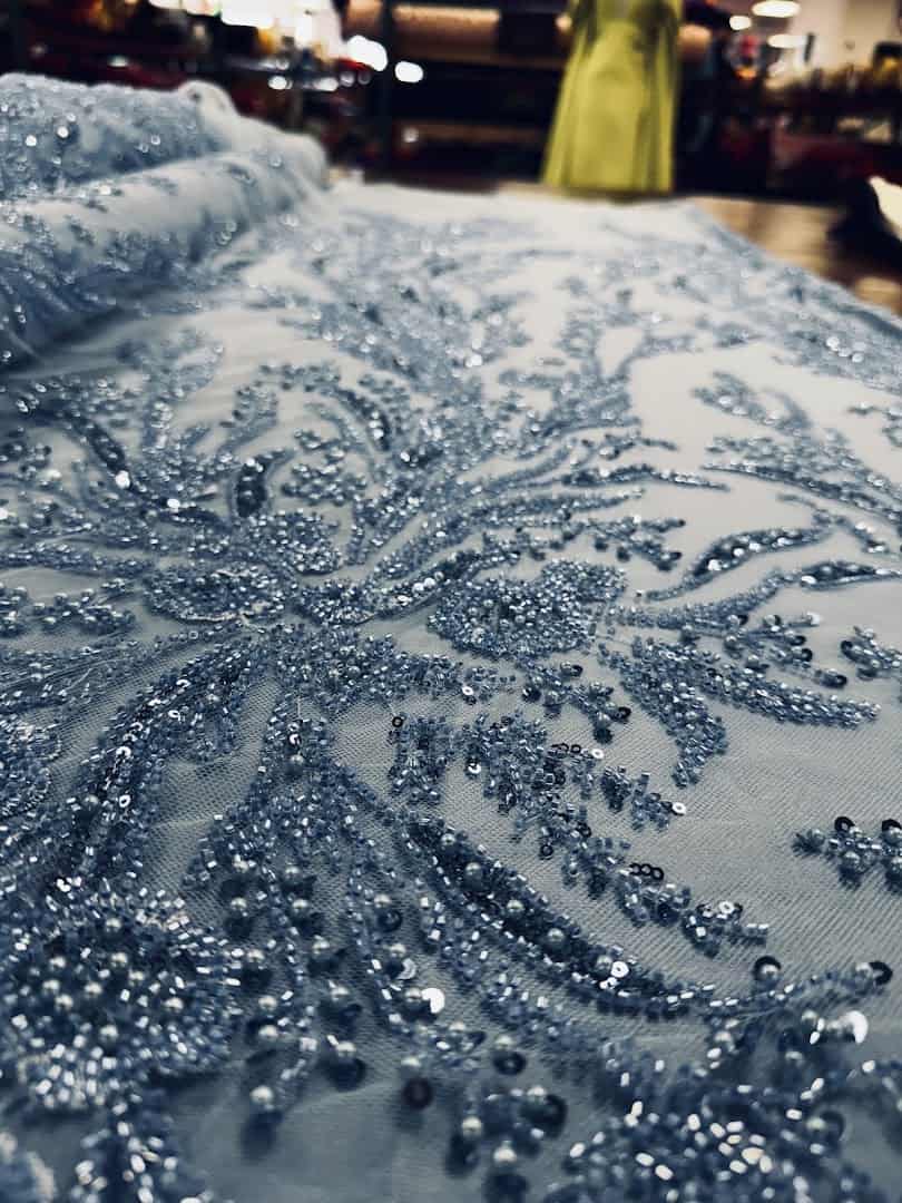 Blue beaded bridal lace fabric at Fabrictopia in Houston