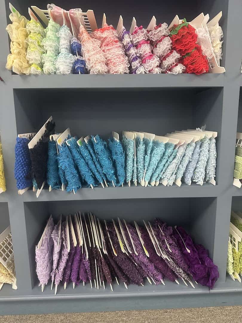Shelves of colorful tulle and ruffled fabrics at Fabrictopia in Houston