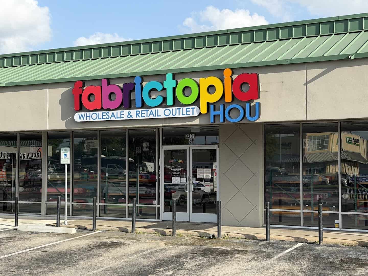 Storefront and sign of Fabrictopia fabric outlet in Houston, Texas
