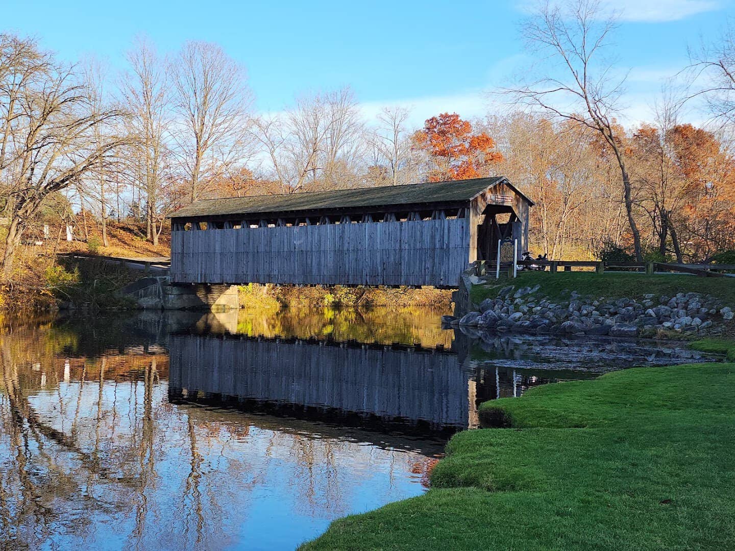 Fallasburg Covered Bridge reflected in the Flat River in fall, Michigan