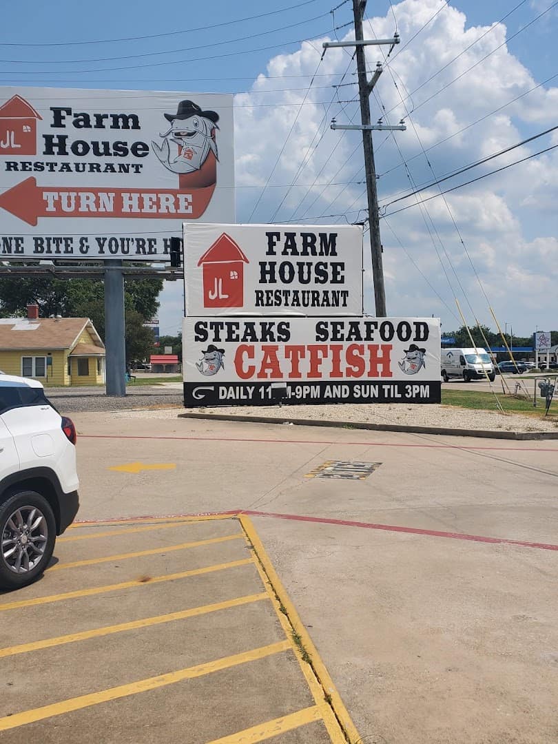 Roadside sign for the Farm House advertising steaks, seafood, and catfish in Mexia, Texas