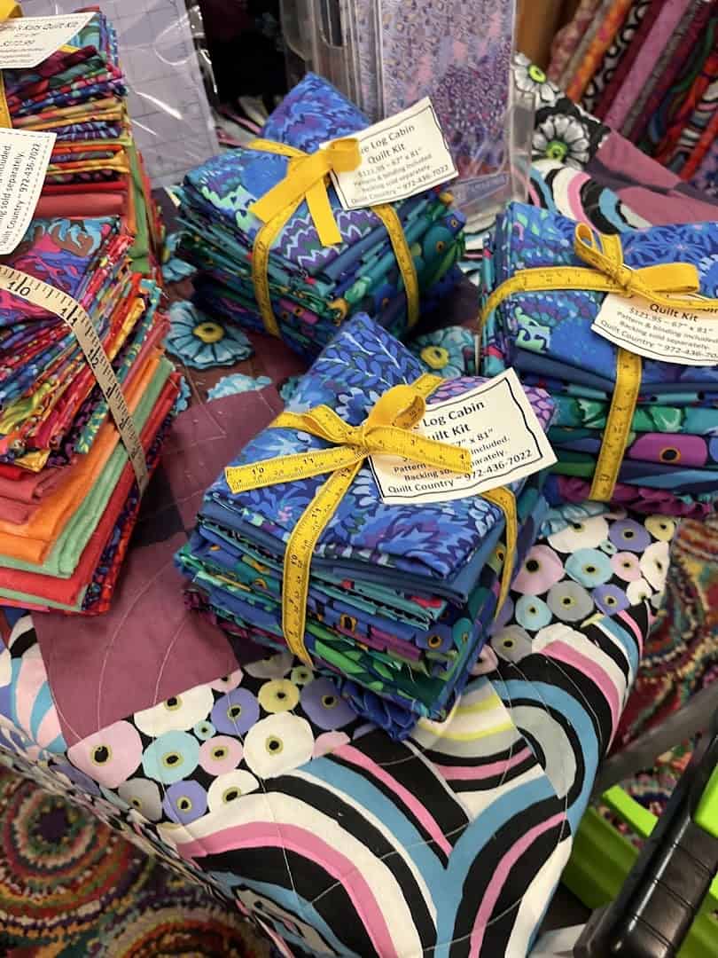 Coordinated fat quarter fabric bundles tied with ribbon at Quilt Country in Lewisville, Texas