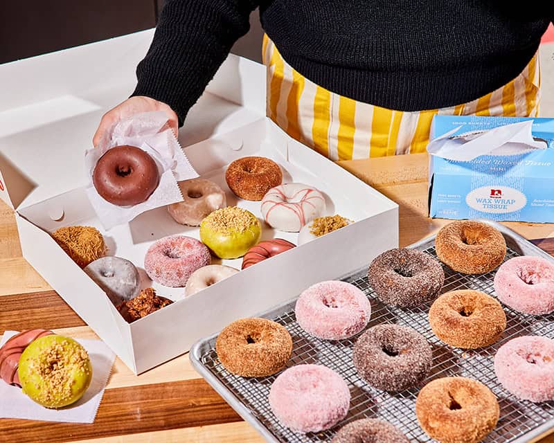 A box and rack of fresh doughnuts at Federal Donuts in Philadelphia, Pennsylvania