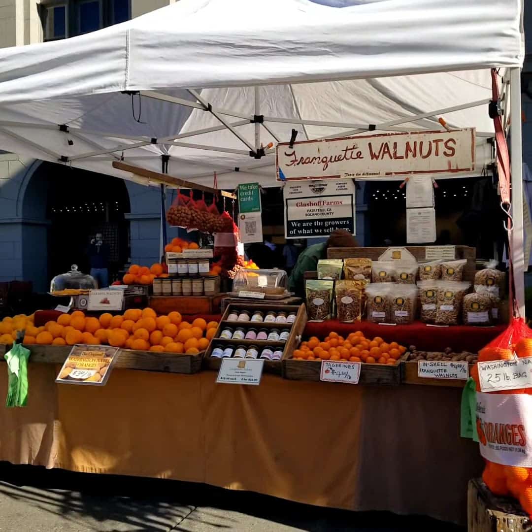 A produce and jam vendor stall at the Ferry Plaza Farmers Market in San Francisco